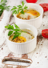 Baked eggs with tomatoes and parsley.