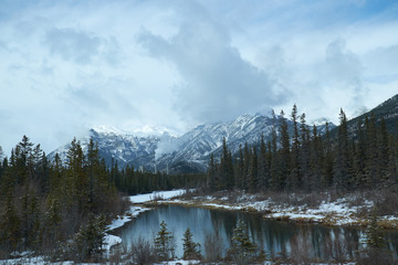Canadian landscape with Rockies Mountains and a lake with reflections