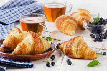 Croissants with Glass Cups of Black Tea