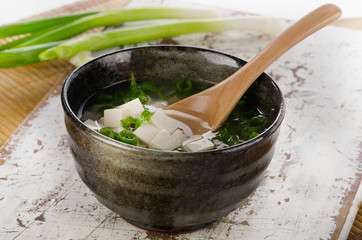 Japanese miso soup on a white wooden table.