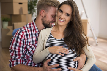 Cheerful couple in their freshly painted apartment