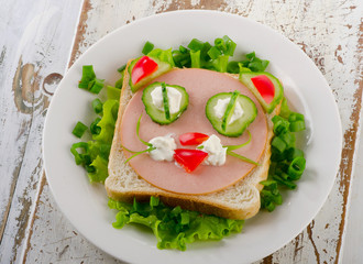Breakfast with a smiling toast and fresh vegetables.
