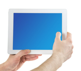 Hands holding tablet PC with blue screen, isolated on white