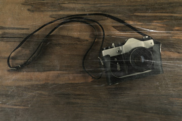 Retro photo camera on wooden background