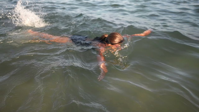 Nice girl swimming in the sea