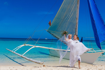young loving couple, bride and groom, on their wedding day on sa