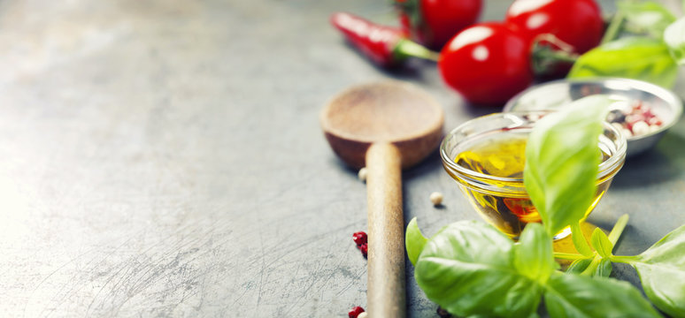 Wooden spoon and ingredients on old background