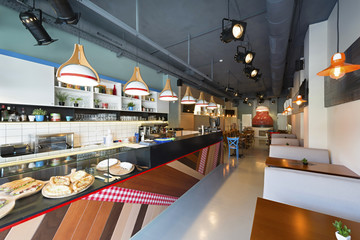 Interior of a pizza restaurant with woode fired oven