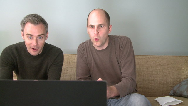 Two men playing a video game in the living room