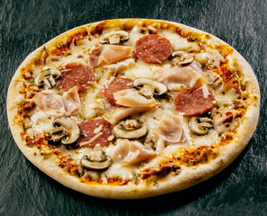 Takeaway Italian pizza with salami and ham