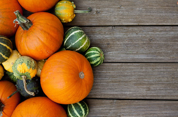 colorful pumpkins on wooden surface
