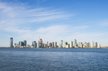 Fototapeta na wymiar City skyline of Jersey City and Hoboken New Jersey from across the waters of the Hudson River