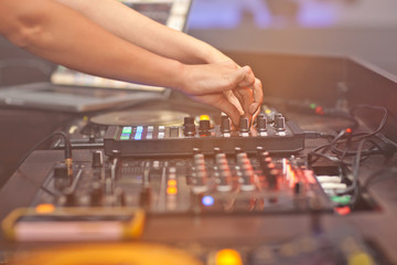 DJ mixing music on console