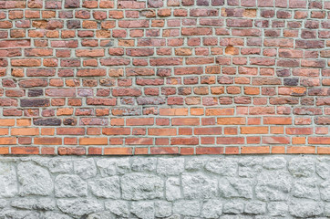 Fototapeta premium Vintage red brick wall with limestone foundation