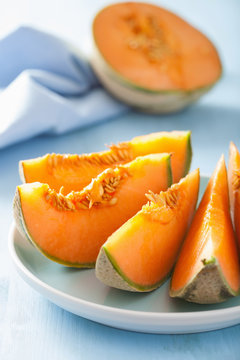 cantaloupe melon sliced on blue plate