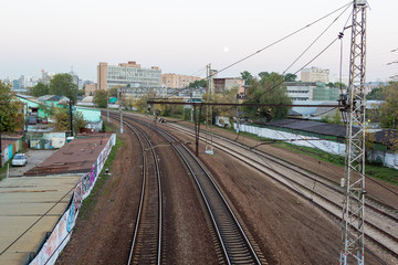 Fototapeta na wymiar evening railway track curve in city