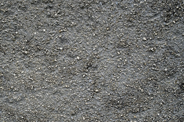 Black old  plaster with small stones wall