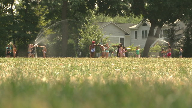 Kids playing in the sprinkler