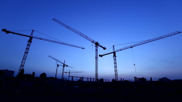 construction site: cranes over clear sky at sunset