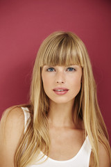 Naklejka premium Flawless young beautiful woman in red studio