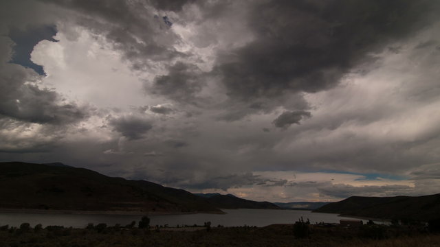 Time Lapse 2012: Time lapse storm clouds billow over a lake.
