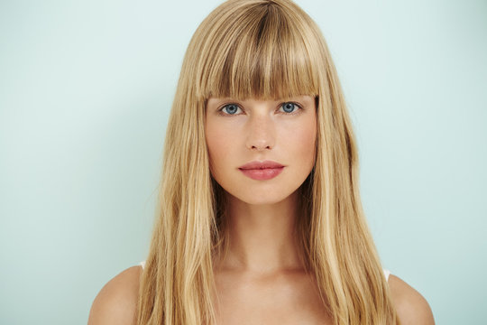 Young blond woman on blue background