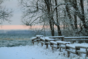 Wooden fence cover by snow in winter