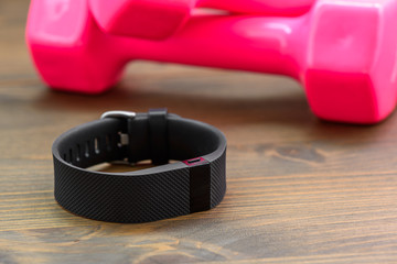 Sports tracker and pink dumb-bell