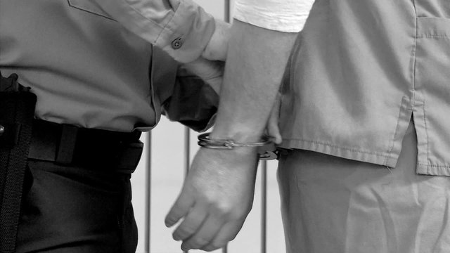 Guard Removes Inmates Handcuffs