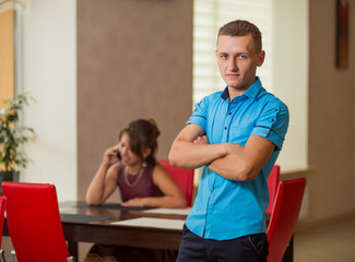man in the background girl with phone