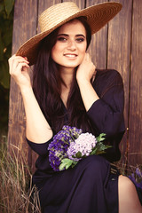 Portrait of a young brunette bride with flowers