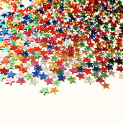 Star background with copy space. Macro. Scattered glittering stars confetti. Vintage photo. Text frame with plenty of colorful stars.