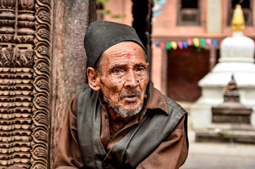 Old Monk on the steps of temple - obrazy, fototapety, plakaty