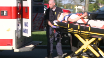 Woman moved by stretcher into ambulance