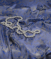 Pearls a necklace on a silk fabric