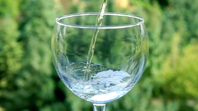 Pouring glass of water in slow motion