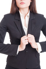 Anonymous business woman adjusting suit jacket