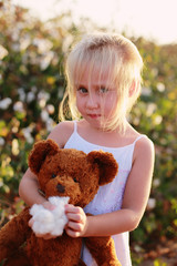 5 years old girl standing in the cotton field