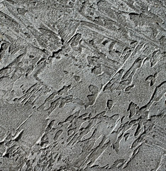 Gray decorative relief plaster on wall