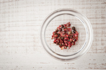 Pink pepper on the glass bowl