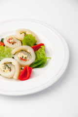 Squid roll with cheese and vegetables on the white background