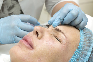 Obraz na płótnie Canvas Cosmetic treatment with injection in a clinic