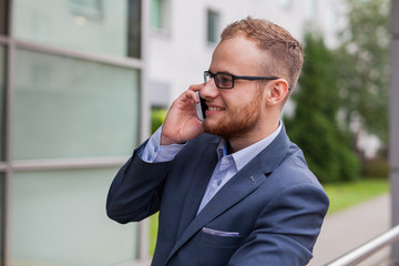 Caucasian businessman outside office using mobile phone on an office terrace.