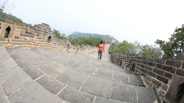 young woman hiker hiking on chinese great wall 