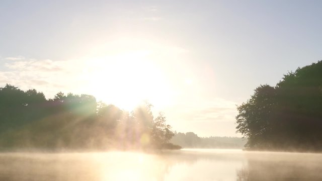 Sunrise at a foggy lake in early fall