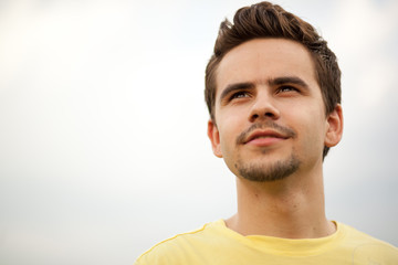 Fototapeta premium Portrait of a young man looking happily ahead