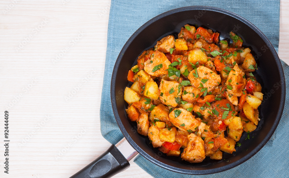 Wall mural meat stew with potatoes, pepper, onion and carrot in a frying pan