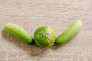 Lime lemon and two cucumbers like people cheers