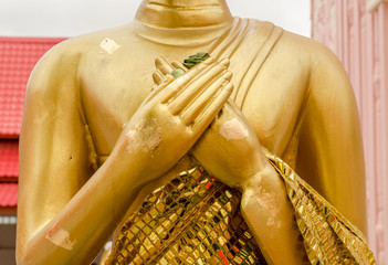 Hand gold Buddha statue at thai temple