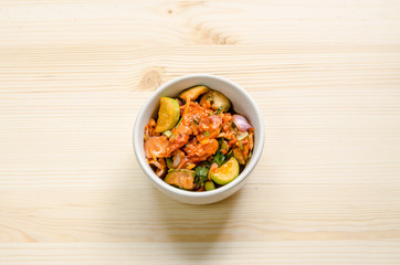 Pickled mussels spicy salad on wooden table, Thai food.